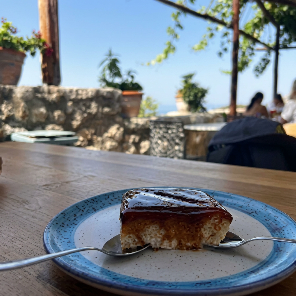 Homemade trileçe cake with caramel sauce on a ceramic plate